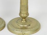 pair of antique brass candlesticks with etched designs on the bases