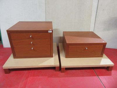 pair of nightstands with drawers on top of each other on a red tile floor