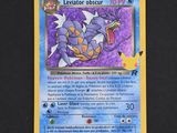a close up of a pokemon card on a black surface