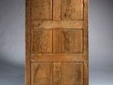 an old wooden cabinet with four doors and four drawers