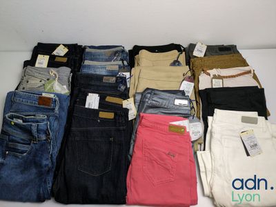 a lot of jeans that are sitting on a table