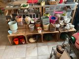 many pots and pans on the shelves in the kitchen