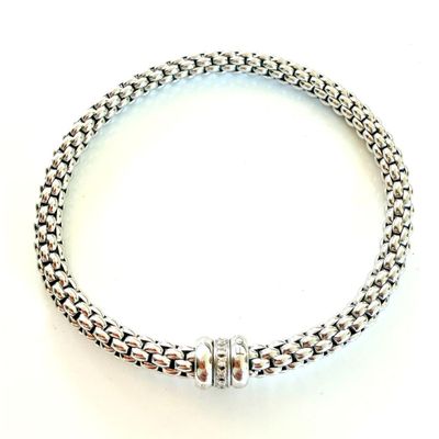 a close up of a silver bracelet with a clasp on a white background
