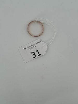 a ring with a string attached to it on a white surface