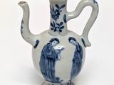 a blue and white vase with two people on it