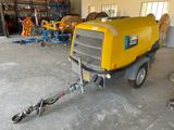 a trailer with a trailer attached to it in a garage