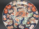 a close up of a plate on a black surface with flowers