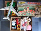 deux boîtes de jouets et un petit avion en plastique posés par terre