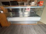 a glass display case in the middle of a kitchen