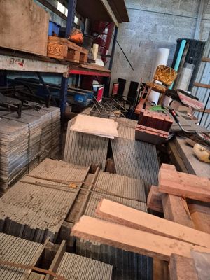 many pieces of wood stacked on top of each other in a room