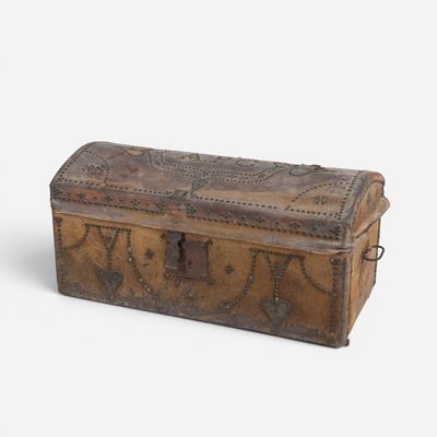 an old wooden trunk with a metal latch on it