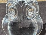 a glass owl figurine sitting on a table