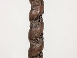 an image of a tall wooden pillar with a carved design on it
