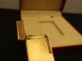 a gold cigarette case with a cross on it