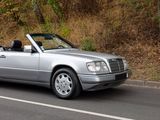 a silver car that is driving down the road