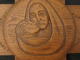 a wooden carving of a woman holding a baby