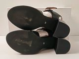 pair of women ' s black leather shoes stacked on top of each other