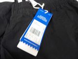 the back of a pair of black pants with a price tag on it
