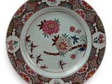 a plate with a bird and flowers design on it