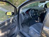 the interior of a car with the door open and the driver ' s seat down