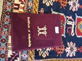 a passport sitting on top of a rug on the floor