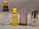 three different perfume bottles sitting next to each other on a table