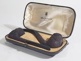 a pipe in a case that is sitting on a table