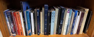 many books that are on a shelf in a book case