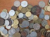 a pile of coins sitting on a wooden table