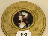 an image of a gold box with a picture of a woman on it