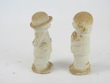 two figurines that are standing next to each other