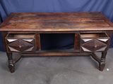 an old wooden desk with two drawers on top of it