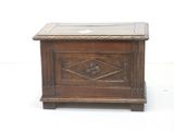 a small wooden box with a glass top on a white surface