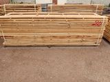 several pieces of wood stacked on top of each other in front of a building