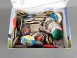 a box full of buttons and magnets sitting on a table