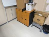 a pile of boxes and a printer in a room
