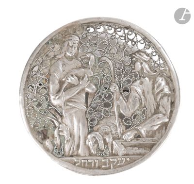 an image of a silver coin with a picture of a man and a woman