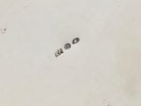a white plate that has two small buttons on it
