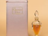christian dior perfume bottle next to a small glass perfume bottle