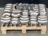 a pallet with many different types of pipes and fittings
