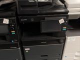 many printers and scanners stacked on top of each other