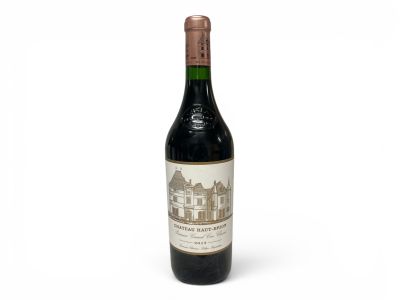 bottle of red wine on a white background with a building in the background