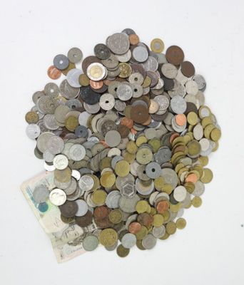 a pile of coins sitting on top of a white table