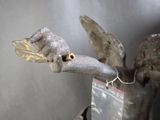 a statue of a bird with a feather on it ' s head