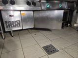 une grande cuisine en inox avec beaucoup de plans de travail