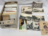 beaucoup de vieilles cartes postales dans une boîte posée sur une table