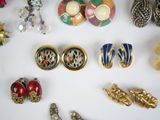 many different types of jewelry on a white surface