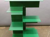 a green shelf with three shelves on top of it