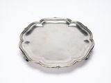 a silver tray with a handle on a white surface