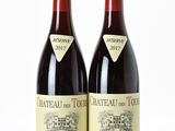 two bottles of wine sitting next to each other on a white surface